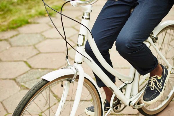 Legs of fit girl with bicycle standing on trottoire