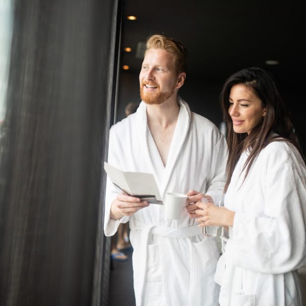 Beautiful happy young couple enjoying wellness spa resort treatments